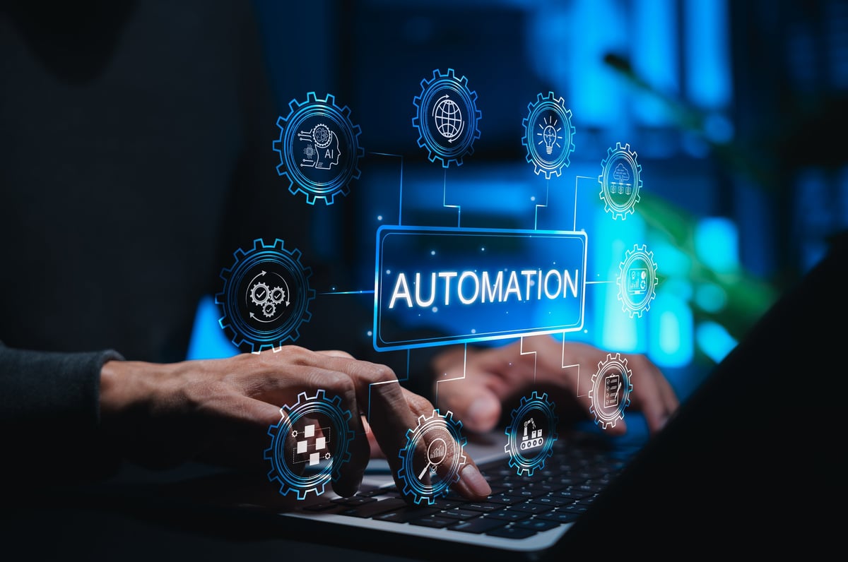 Automation concept in technology and business. Person using laptop while gear icons symbolizing AI, workflow automation, data analysis, cloud computing.